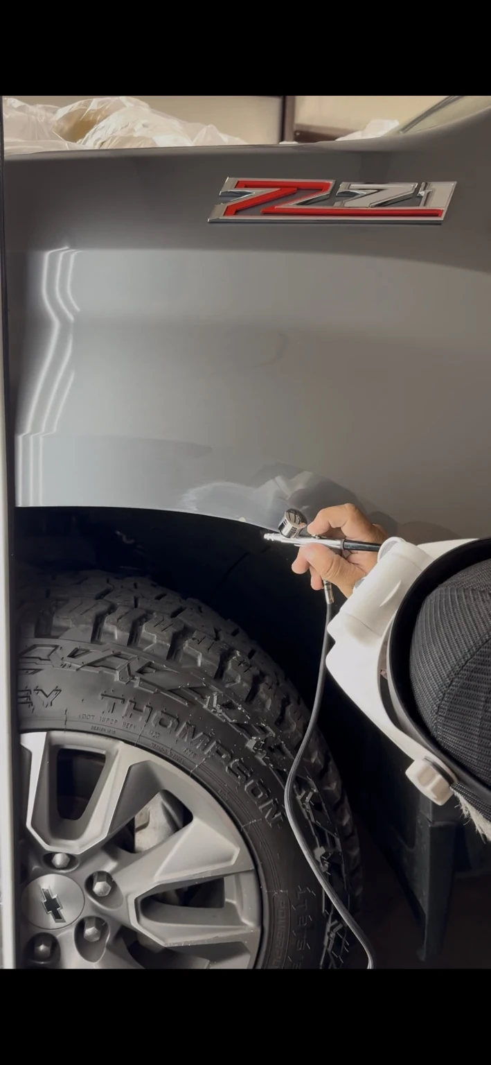 Actual touch-up paint application on a vehicle fender